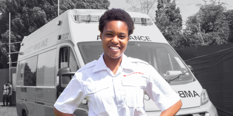 Irish Red Cross volunteer poses in front of an ambulance